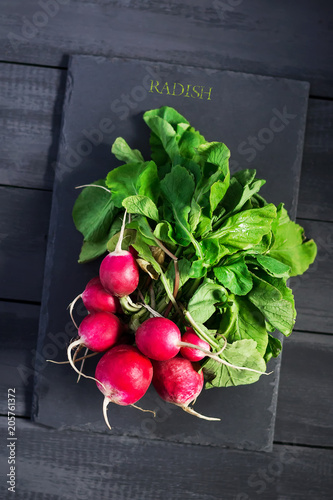 Fresh radish on stone cutting board. Copy space. Natural, organic products. photo