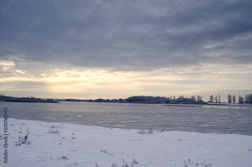 frozen lake in winter at sunset