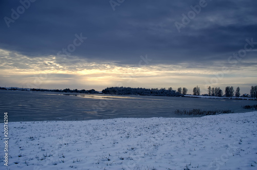 frozen lake in winter at sunset © Вячеслав Лелюга