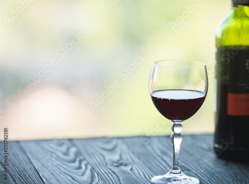 Wine glass in room among sunset window background
