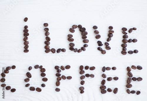 I Love Coffee phrase spelled out of roasted coffee beans isolated on white background