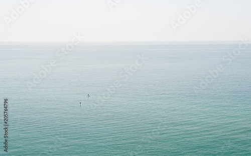 People paddle surfing