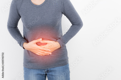 asian woman having stomach ache on white background photo