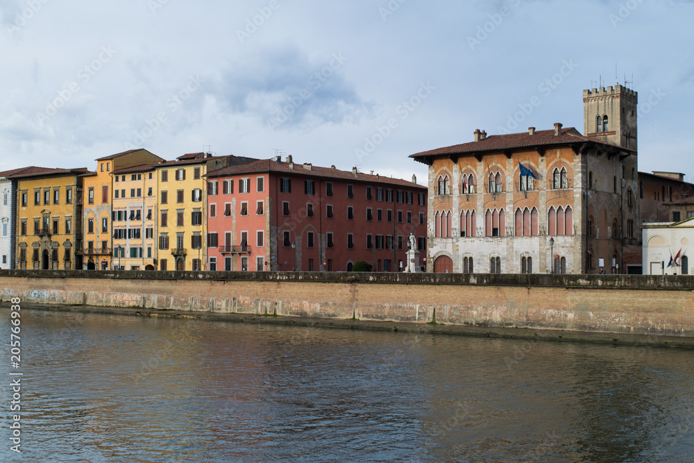 Colourful old buildings along the riverfront of the Arno in Pisa, Italy