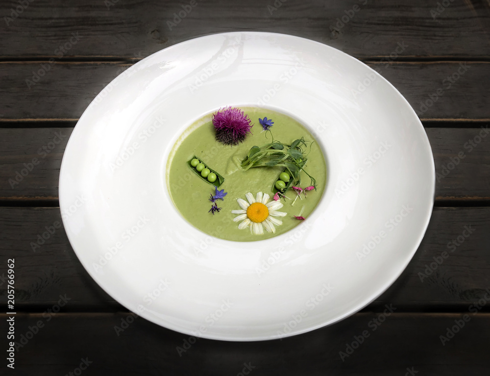 Vegetable soup mashed green peas and broccoli, decorated with flowers and fragrant herbs. Enjoyed the dish Vegetable soup mashed green peas and broccoli, decorated with flowers and fragrant herbs. Enjoyed the dish