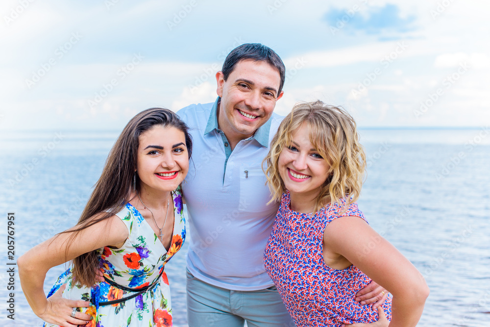 Funny positive girls laugh and rest jump on the sea. The concept of friends friendship and relations Funny positive girls laugh and rest jump on the sea. The concept of friends friendship and relations