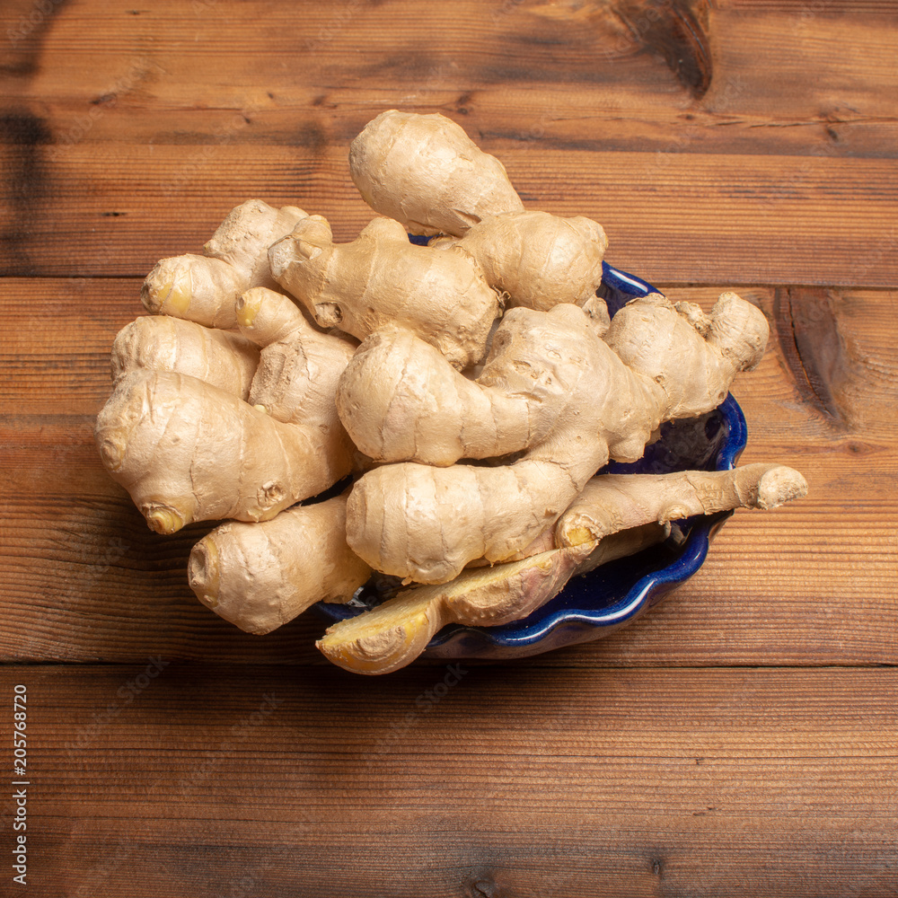 Fresh big ginger root close up copy space on wooden background