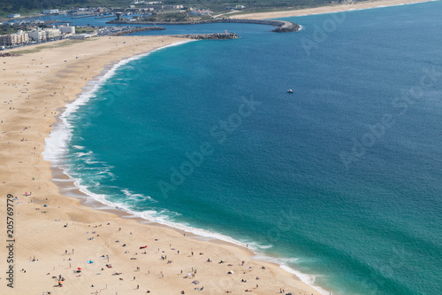 Beach of Nazare up to the harbour entrance in Portugal
