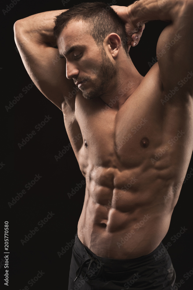 Strong athletic man showes naked muscular body Strong athletic man showes naked muscular body