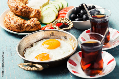 Traditional Turkish breakfast with fried eggs and tea