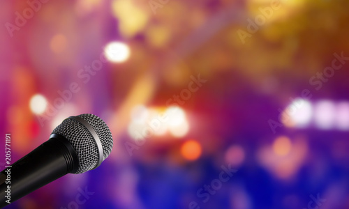 Microphone with blurred colorful bright light in dark night background, soft focus image for business technology communication concepts