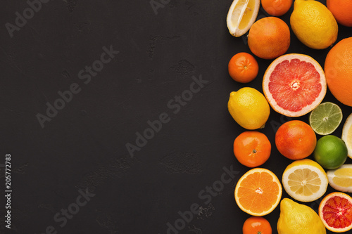 Variety of ripe citruses on black background