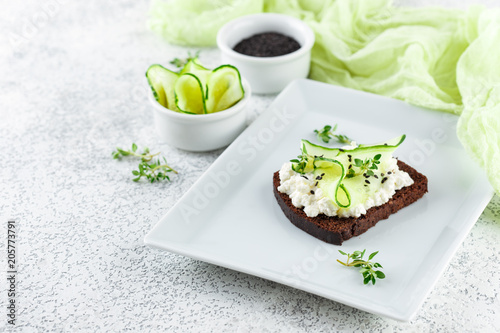 Toasts with ricotta, cucumber and black sesame