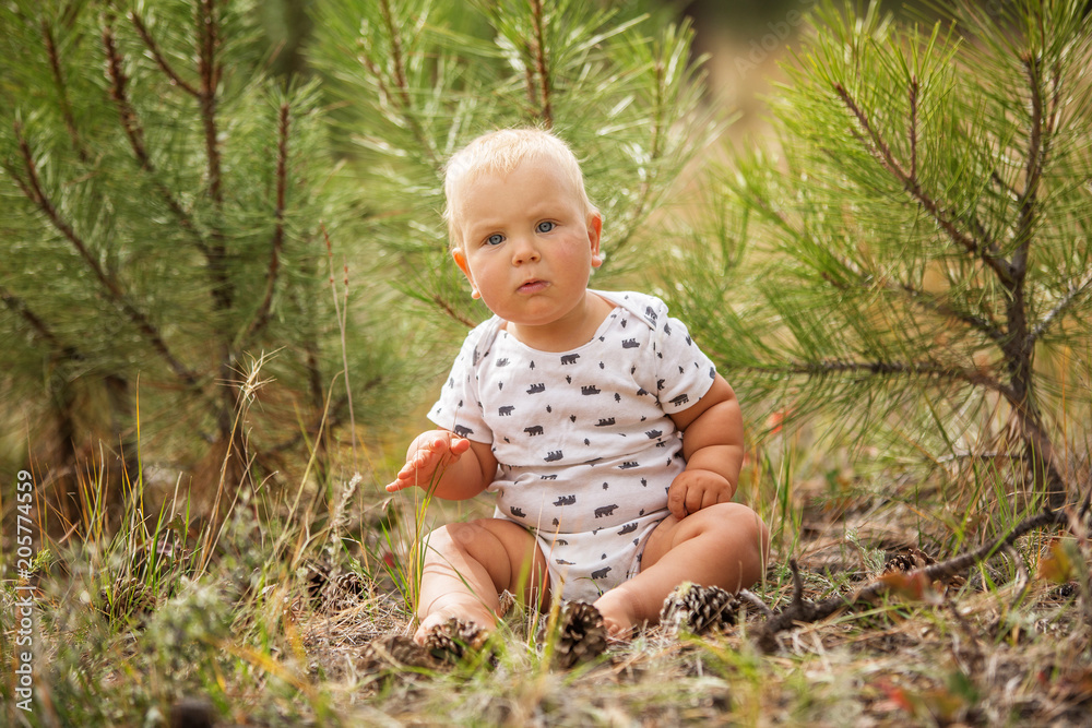 Portrait of a baby boy in green pine forest Portrait of a baby boy in green pine forest