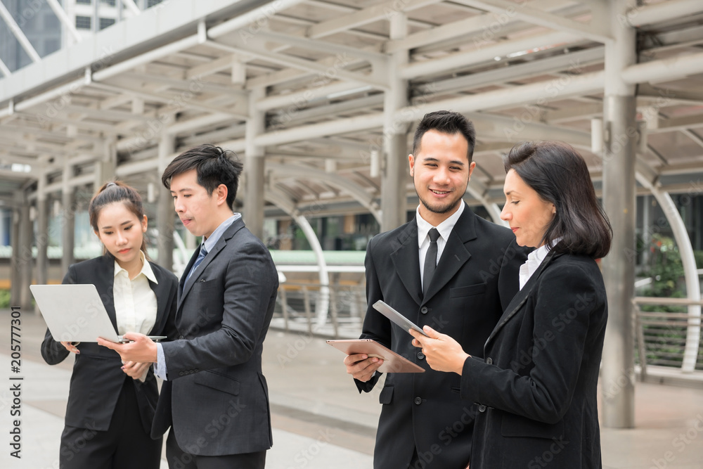Business team discuss project in town Business team discuss project in town