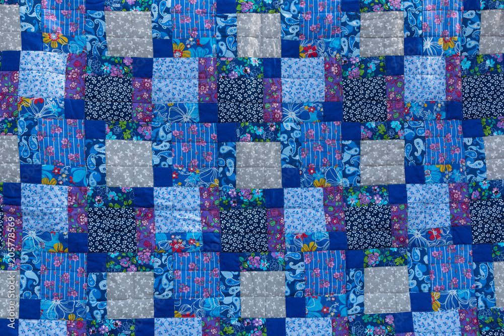 Fototapeta premium Made by hand from colored cloth fabrics, beautiful blankets. Patchwork. Needlework. Background.