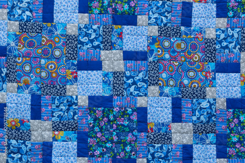Made by hand from colored cloth fabrics, beautiful blankets. Patchwork. Needlework. Background.