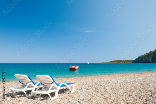 Two chaise lounges on the beach in Kemer, Turkey.