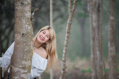Portrait of beautiful asian woman gold hair outdoor,Happy woman concept,Lifestyle of modern girl,Thailand people on the road in the forest