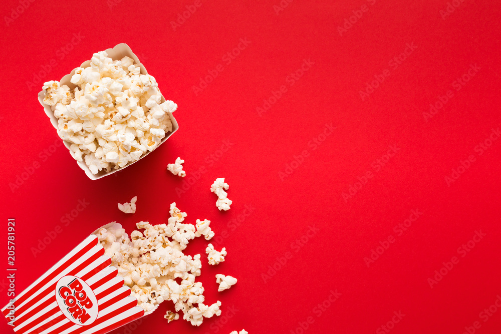 Bucket of popcorn on red background, top view Bucket of popcorn on red background, top view