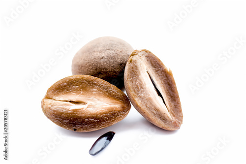 Sliced organic ripe chikoo or Sapodilla or Manilkara zapota isolated on white. photo