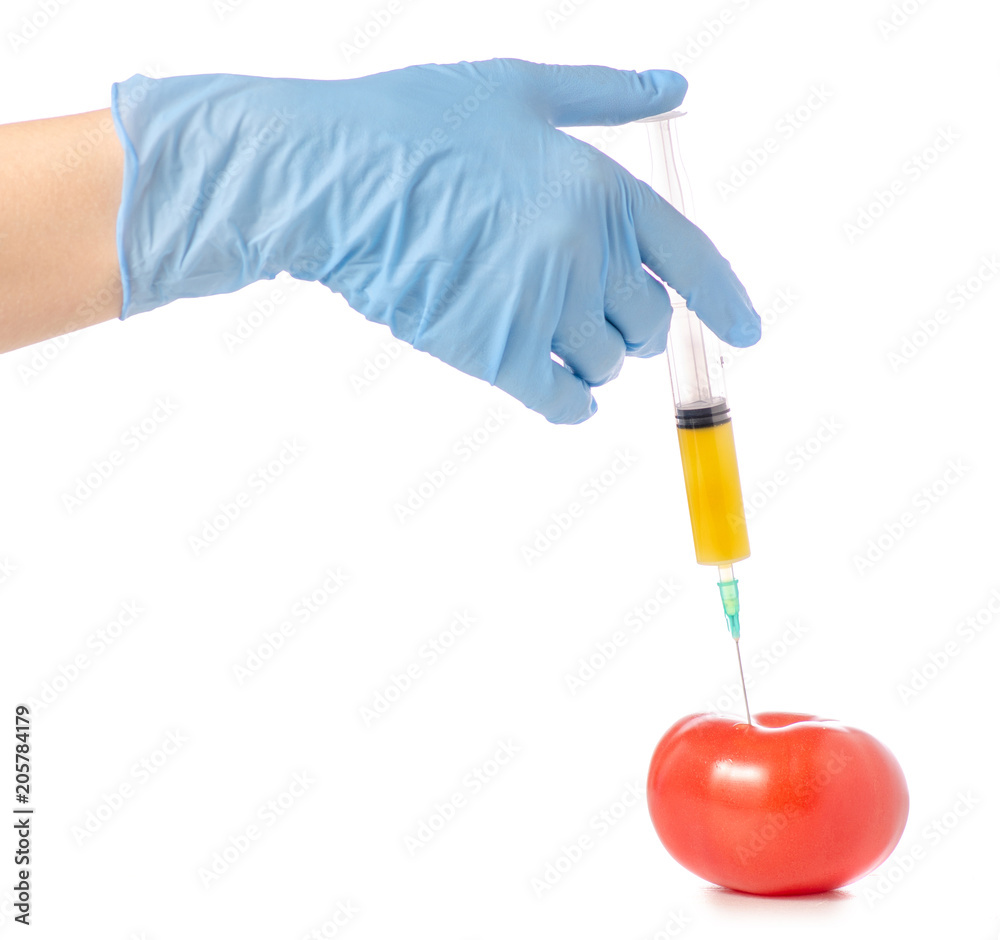 Syringe in the hands of tomato on a white background isolation Syringe in the hands of tomato on a white background isolation