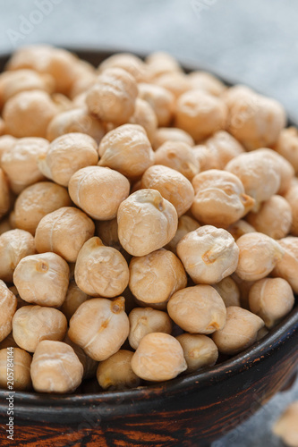 Raw Chickpeas in a brown clay bowl