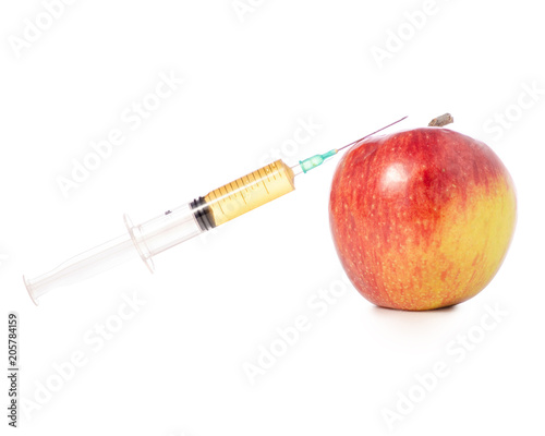 Syringe in apple on a white background isolation