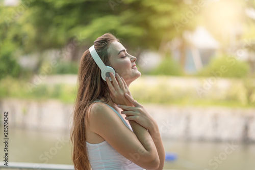 Young woman enjoy listening to music with headphones, happy and relaxing time