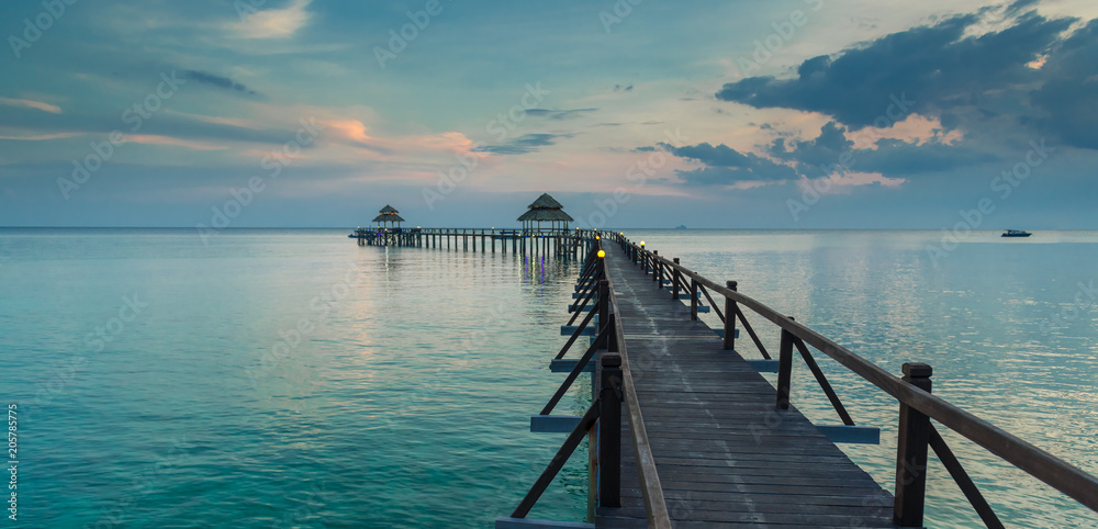 Wooden walkway leads out into the sea. Tioman, Malaysia