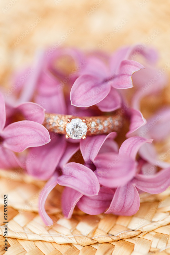 jewelry engagement ring with diamonds and spring lilac flowers jewelry engagement ring with diamonds and spring lilac flowers