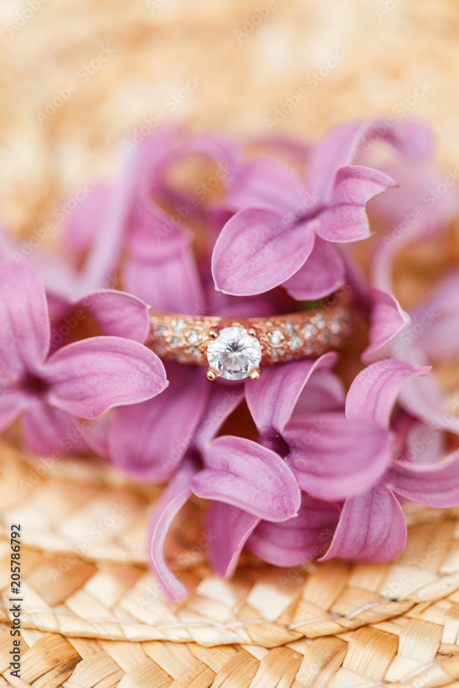 jewelry engagement ring with diamonds and spring lilac flowers jewelry engagement ring with diamonds and spring lilac flowers