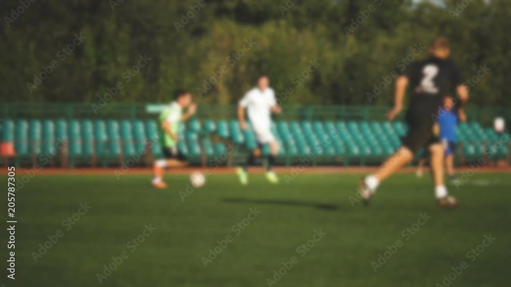 Player is attacking, amateur soccer game at the small stadium in slow motion Player is attacking, amateur soccer game at the small stadium in slow motion