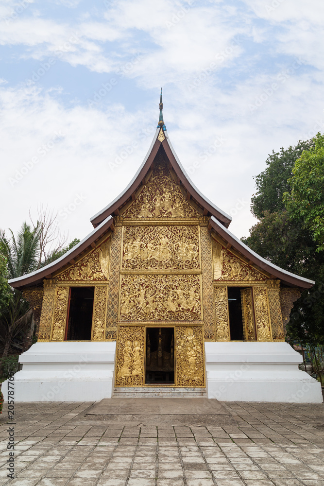 Fototapeta premium Front view of the ornate Funeral chapel at the Wat Xieng Thong temple (