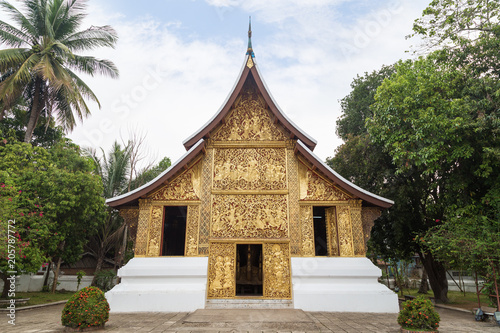 Front view of the ornate Funeral chapel at the Wat Xieng Thong temple ("Temple of the Golden City") in Luang Prabang, Laos.