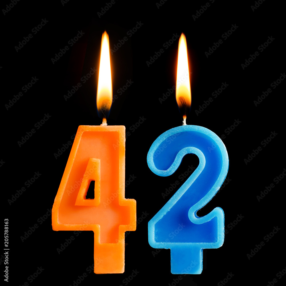 Burning birthday candles in the form of 42 forty two for cake isolated on black background. Burning birthday candles in the form of 42 forty two for cake isolated on black background.