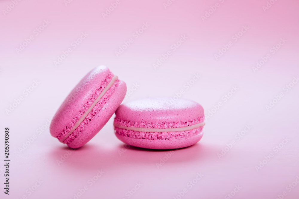 pink macaroons on pink background. pink macaroons on pink background.
