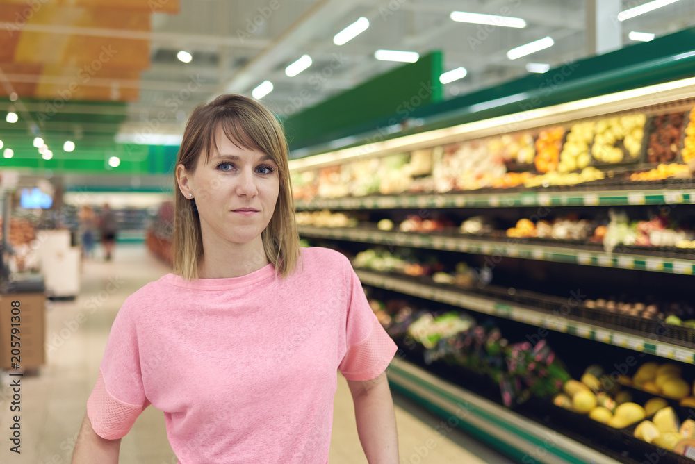Slender young woman in a supermarket at the vegetables shelf. Slender young woman in a supermarket at the vegetables shelf.