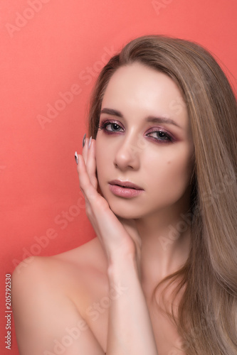 Beautiful young girl on a orange background.