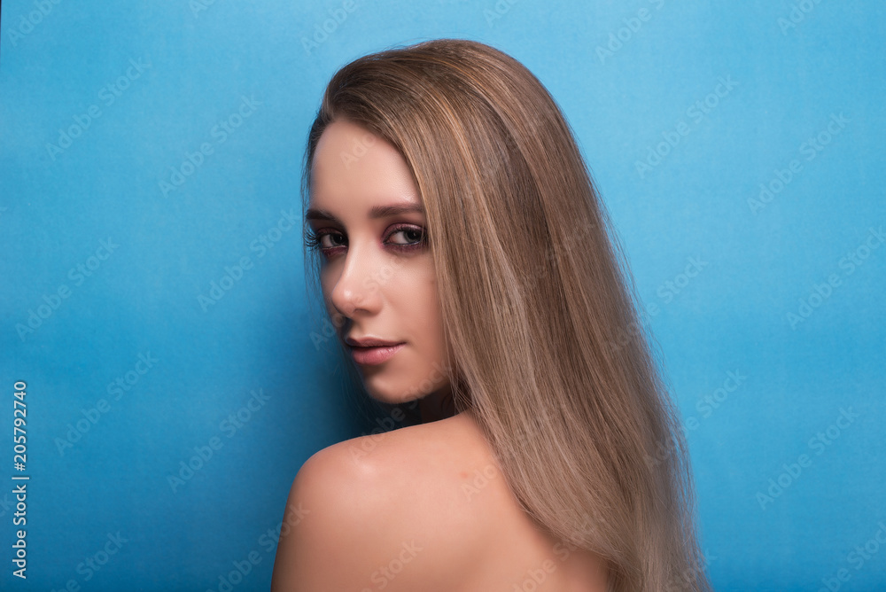Beautiful young girl on a blue background. Beautiful young girl on a blue background.