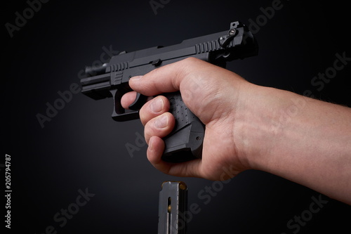reloading a handgun, inserting ammunition clip