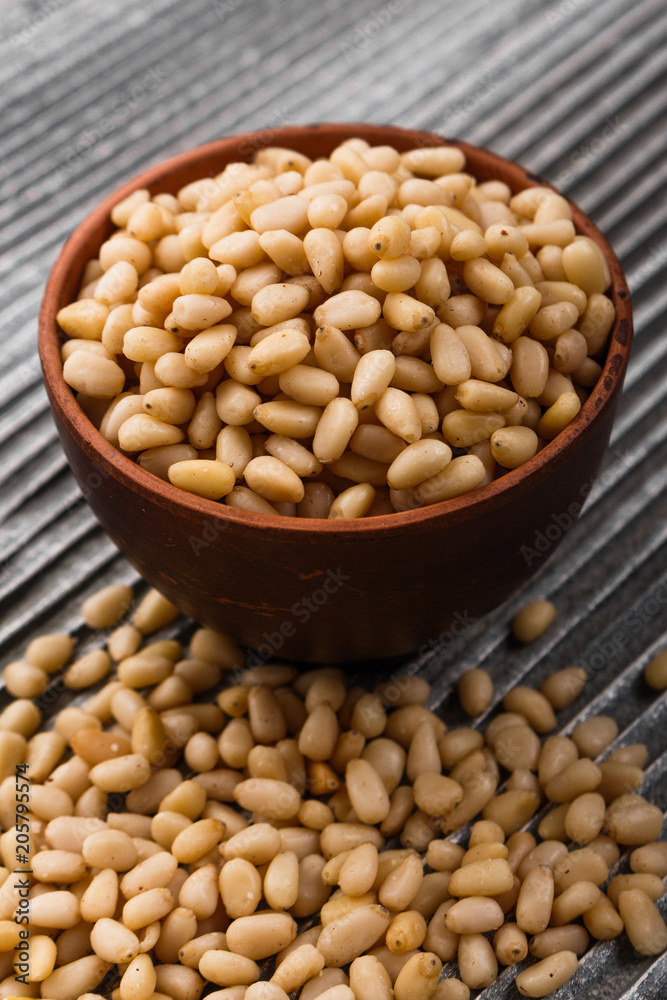 peeled pine nuts on a rustic background peeled pine nuts on a rustic background