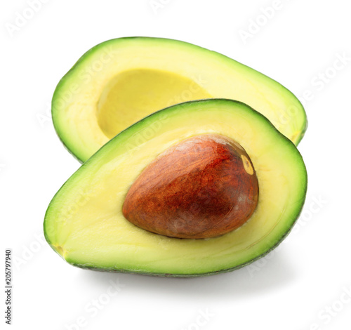 two halves of cut ripe avocado isolated on white background