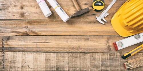Foto Project construction blueprints and engineering tools on wooden desk, copy space