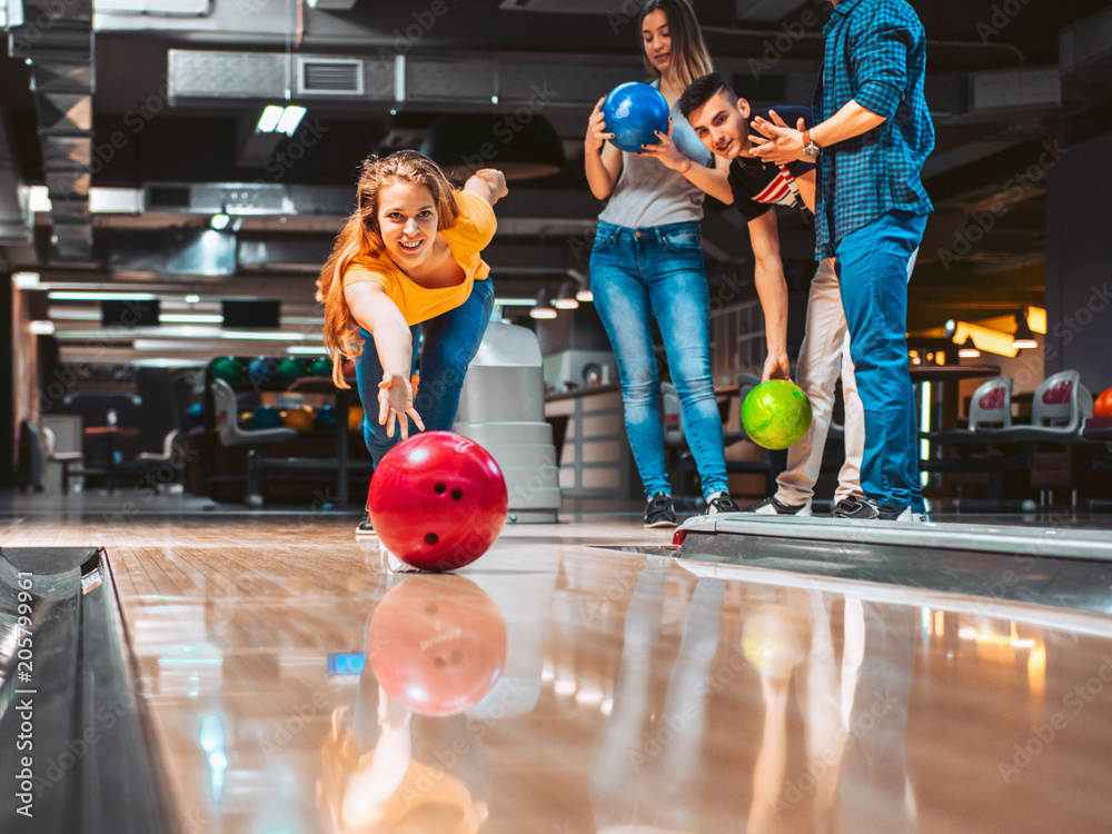 Fototapeta premium Friends having fun while bowling, happy hour