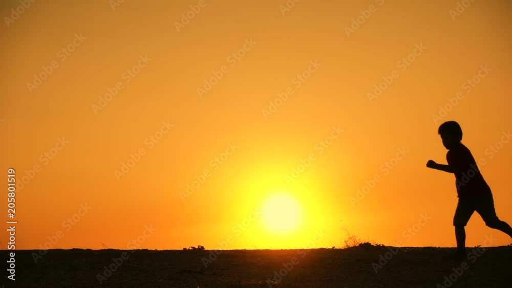 silhouette of five kids family runniing at sunset silhouette of five kids family runniing at sunset