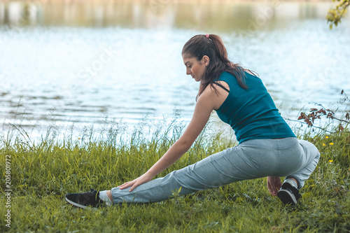 Beautefull girl with fitness exercise for relax and healthy at lake, Nature background, Concept outdoor sport and health photo