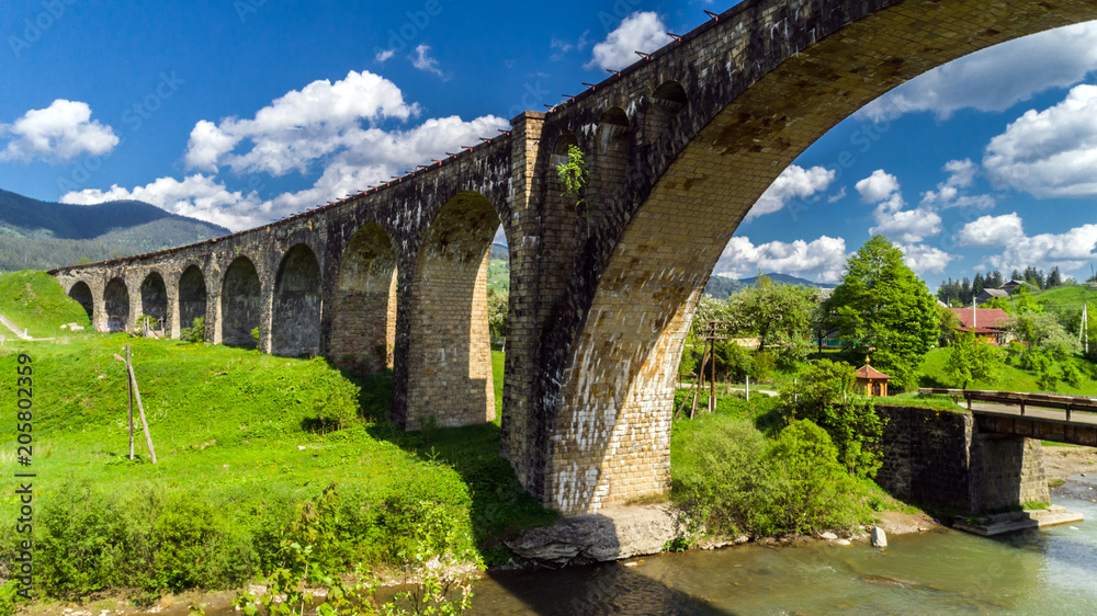 Fototapeta premium Old railway bridge, old viaduct Vorohta, Ukraine. Carpathian Mountains, wild mountain landscape.