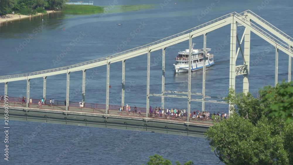 Kiev cityscape. Dnyeper river and Parkovyi Bridge - June 2017: Kiev, Ukraine Kiev cityscape. Dnyeper river and Parkovyi Bridge - June 2017: Kiev, Ukraine