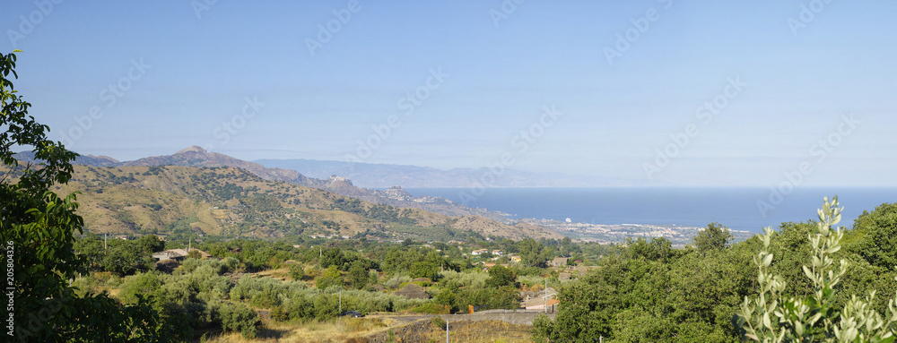 The pictures landscape of Sicily coast with Castelmola, Taormina and Giardini Naxos towns view in the background.Sicily, Italy The pictures landscape of Sicily coast with Castelmola, Taormina and Giardini Naxos towns view in the background.Sicily, Italy
